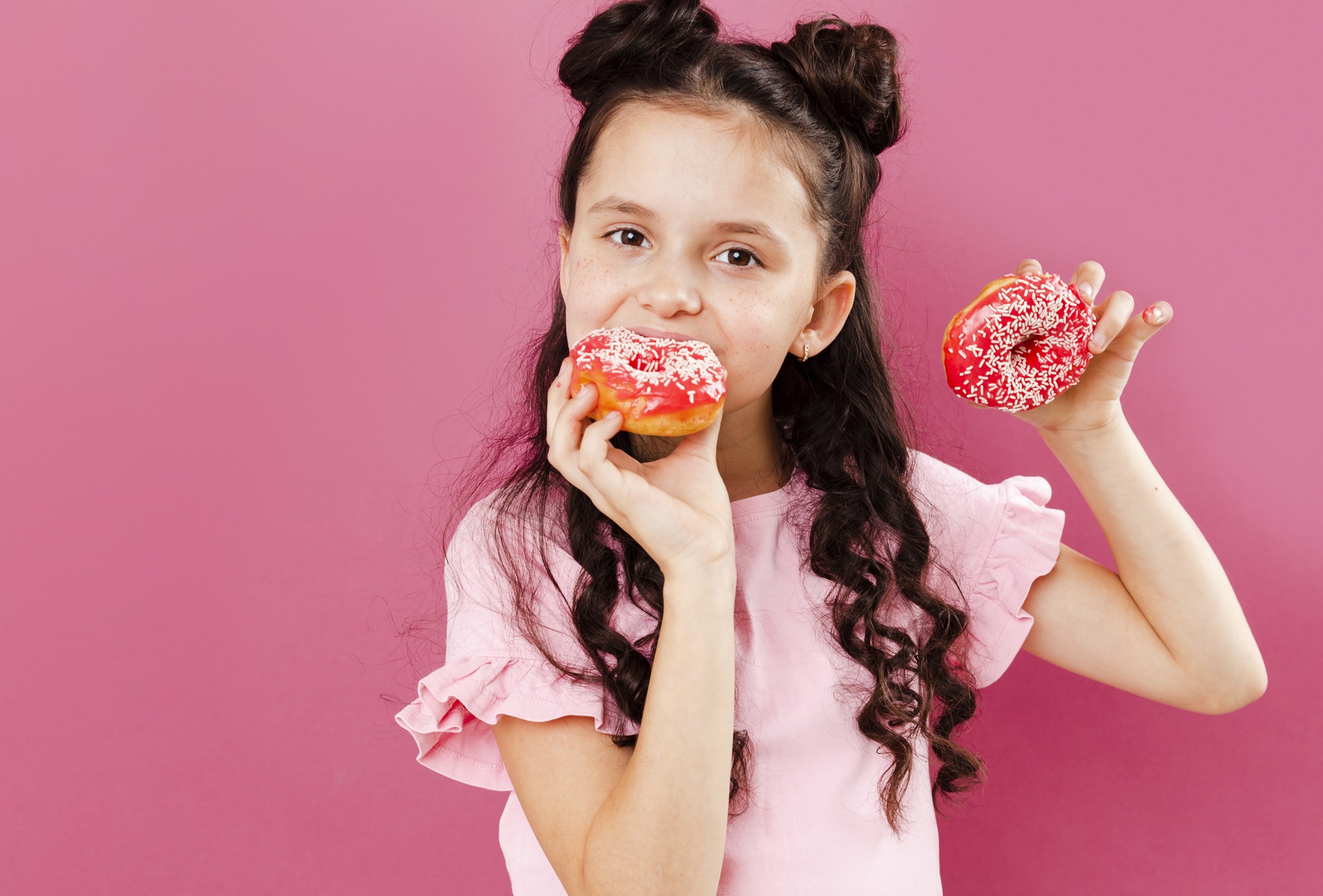 girl-eating-delicious-doughnuts-with-copy-space