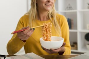 close-up-adult-woman-eating-noodles