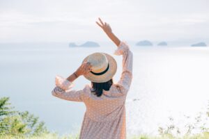 happy-woman-summer-cute-dress-straw-hat-vacation-with-tropical-exotic-views