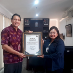 Kepala Kantor Cabang BPJS Kesehatan Denpasar, dr. Nyoman Wiwiek Yulia Dewi (kanan), menyerahkan piagam penghargaan bintang tiga implementasi antrean online MJKN kepada Direktur RSU Bhakti Rahayu Denpasar, Jumat (6/2), di Kantor BPJS Kesehatan Denpasar.